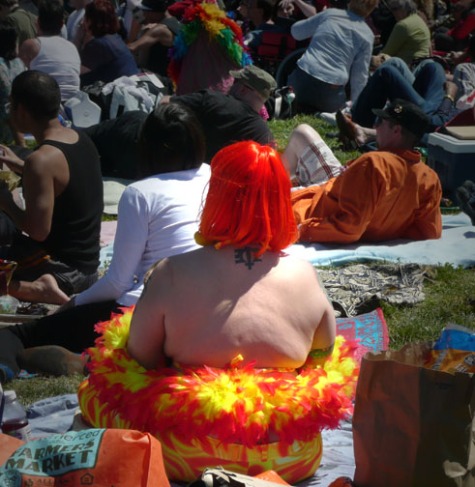 Back of woman with orange hair sundress and feather boa