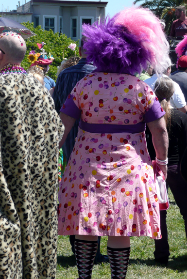 Large woman (man?) pink print dress, purple and pink big hair