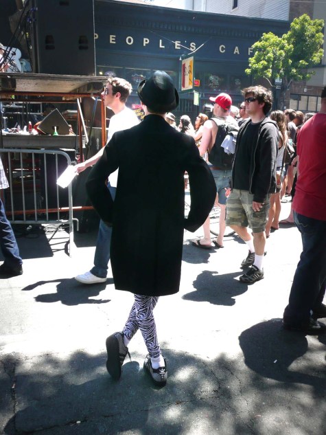 Bay-Area-Backsides-Sarah-Curtiss-Haight-Street-peoples-cafe-man-zebra-legs Man in black coat with zebra tights in front of People's Cafe on Haight Street