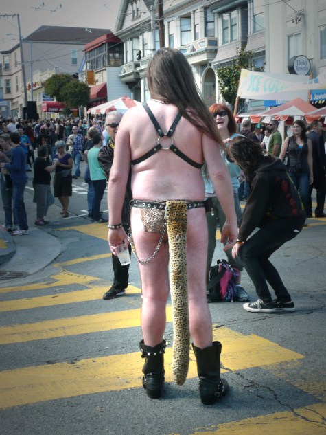 Man with long hair in jockstrap with long tail
