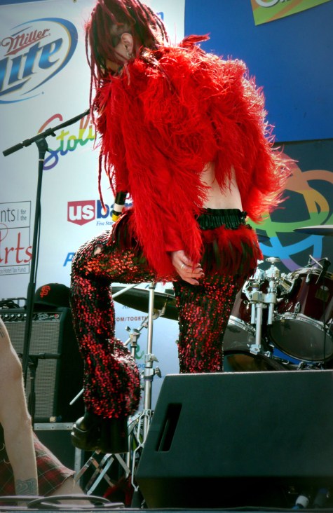 man with red feather shirt red sequin pants red hair