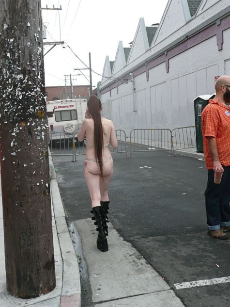 woman with long pony tail and metal bikini