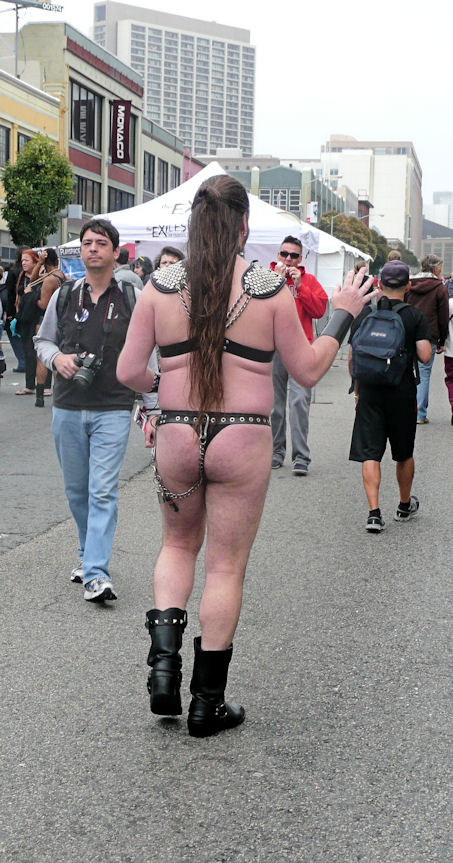 man in leather fetish gear with long ponytail