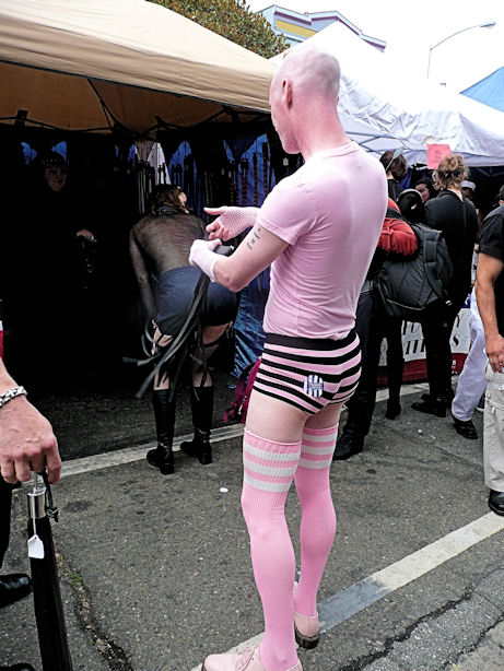 man in pink over the knee socks with matching shirt, short and skin