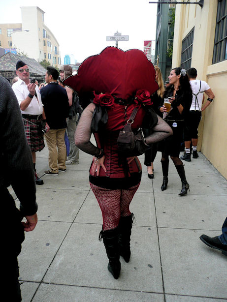 red corset with head ruff and fishnet stockings