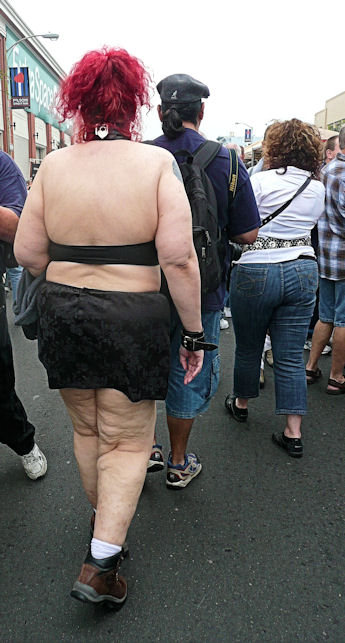 red hair woman with short black skirt and tube top