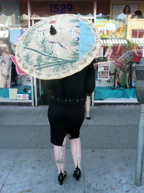 woman with seamed stockings and parasol